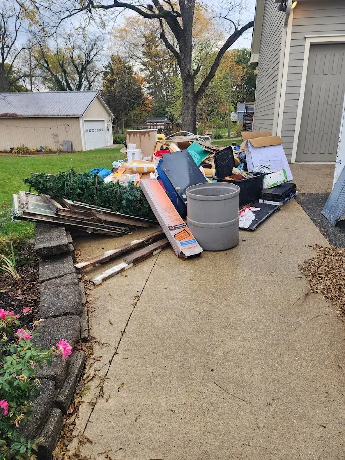 Dumpster being loaded with debris for Estate Cleanout Dumpster Rental in Ellettsville
